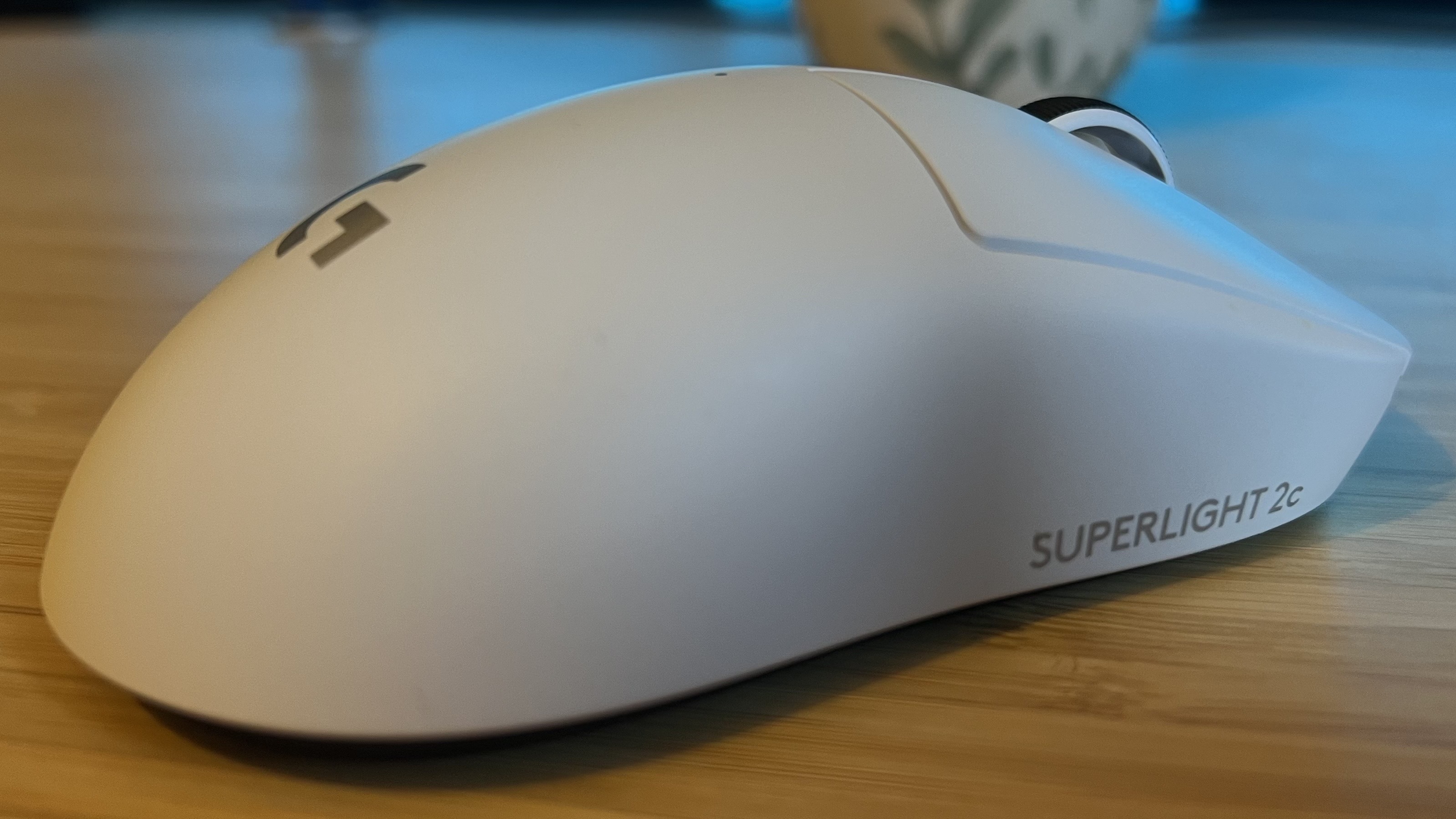 Right side of Logitech G Pro X Superlight 2c gaming mouse on a wooden desk