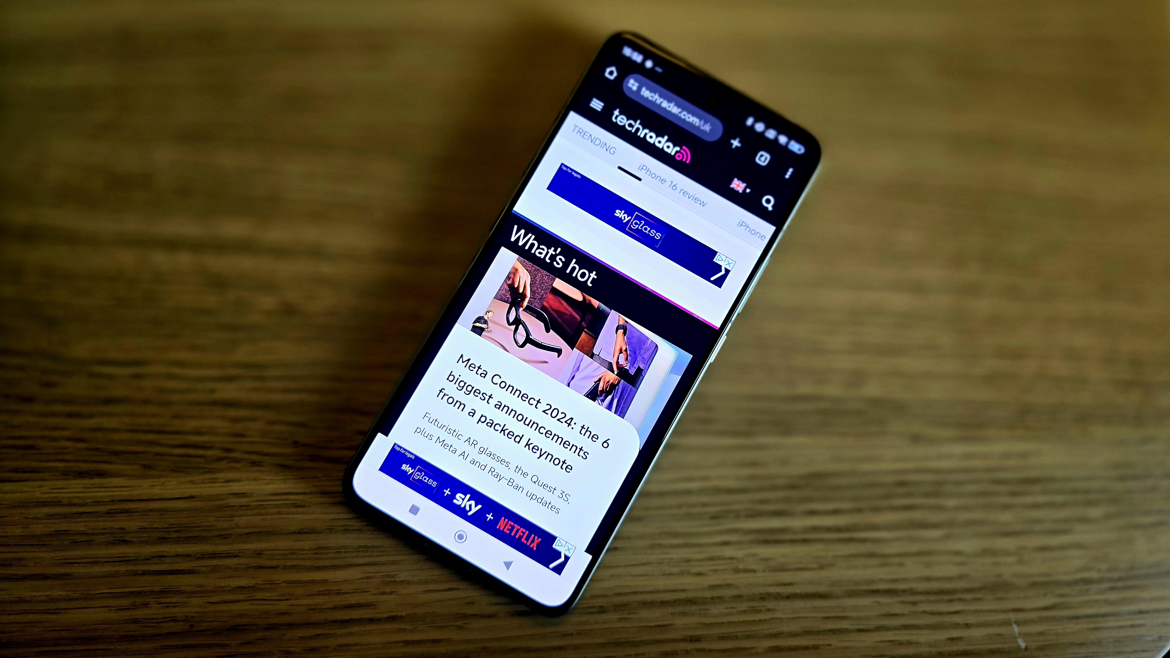 Xiaomi 14T Pro displaying TechRadar homepage on wooden surface