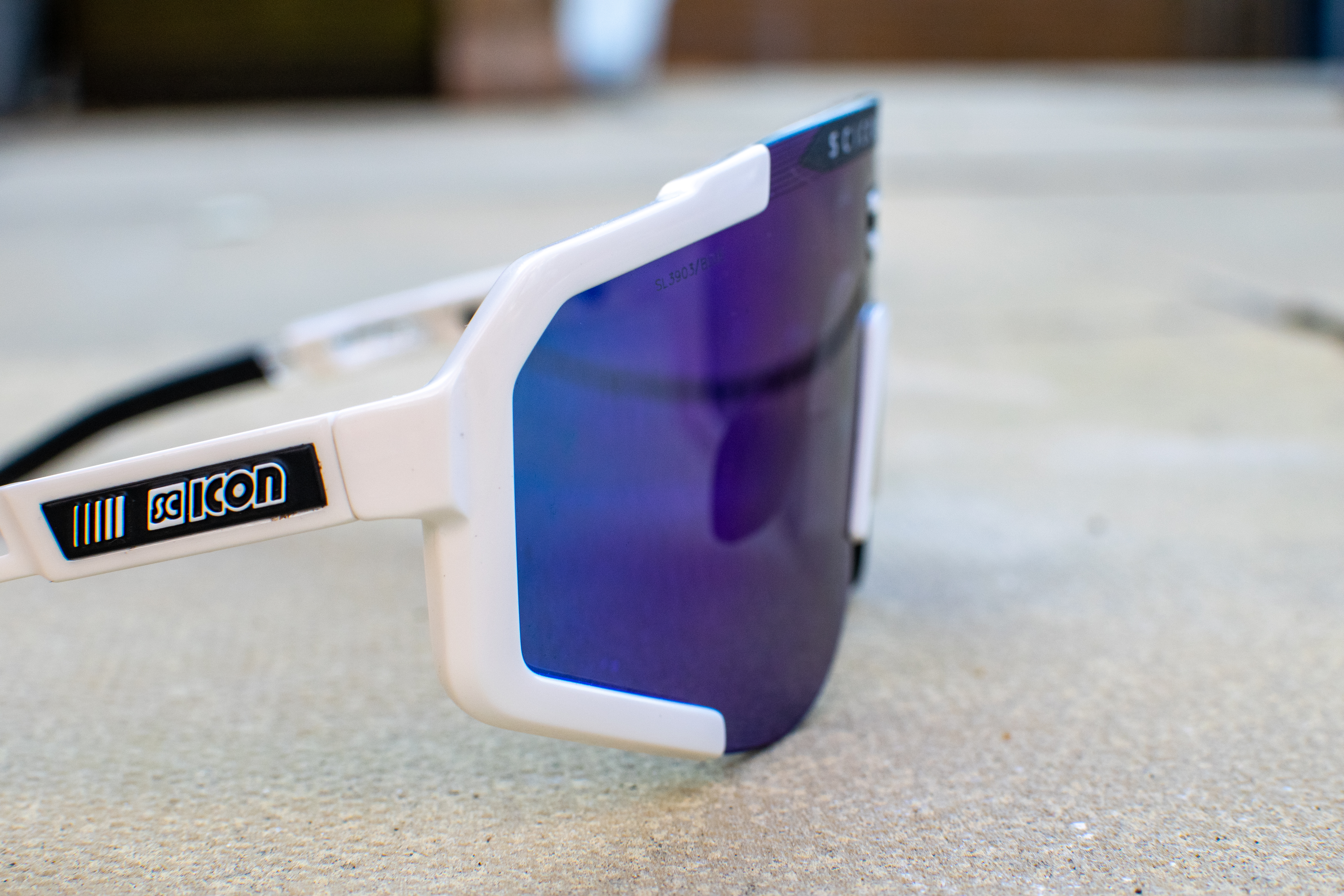 A pair of white and blue scicon aeroscope sunglasses