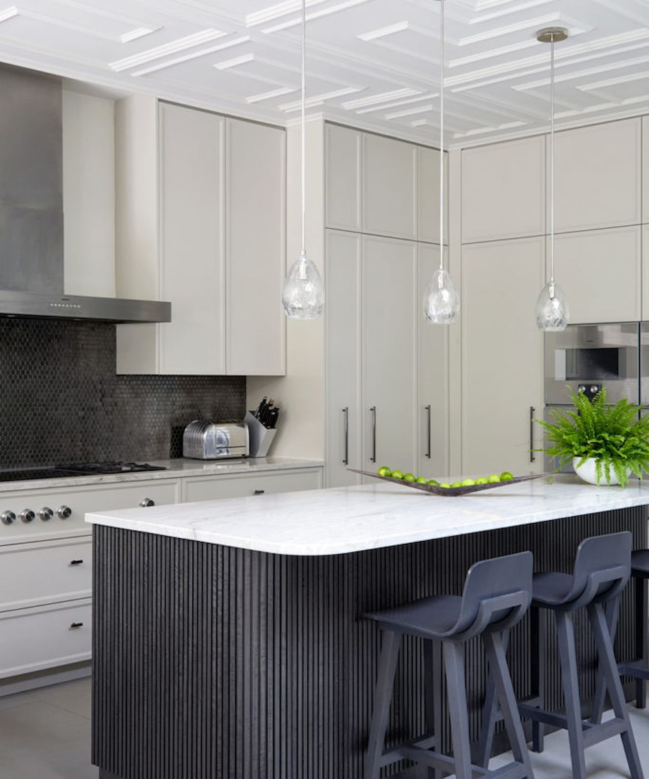 A white top kitchen island with overhead lights