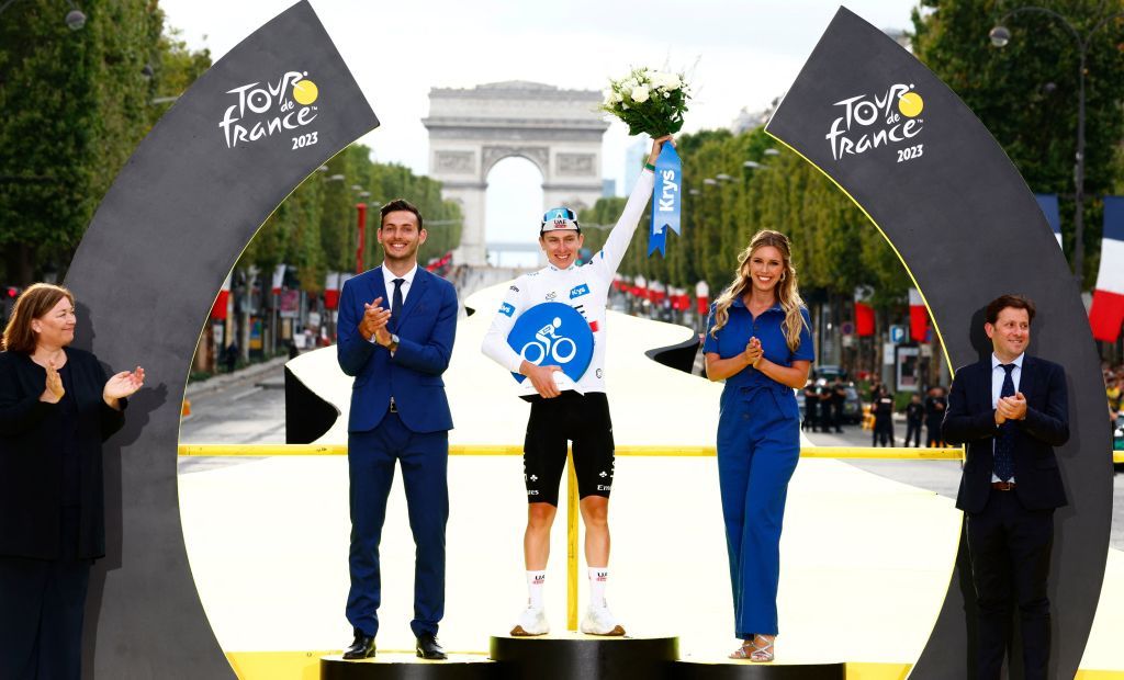 UAE Team Emirates Slovenian rider Tadej Pogacar celebrates on the podium with the best young riders white jersey after the 21st and final stage of the 110th edition of the Tour de France cycling race 115 km between SaintQuentinenYvelines and the ChampsElysees in Paris on July 23 2023 Photo by Etienne GARNIER POOL AFP Photo by ETIENNE GARNIERPOOLAFP via Getty Images