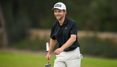 Rasmus Neergaard-Petersen smiles as he walks off the green