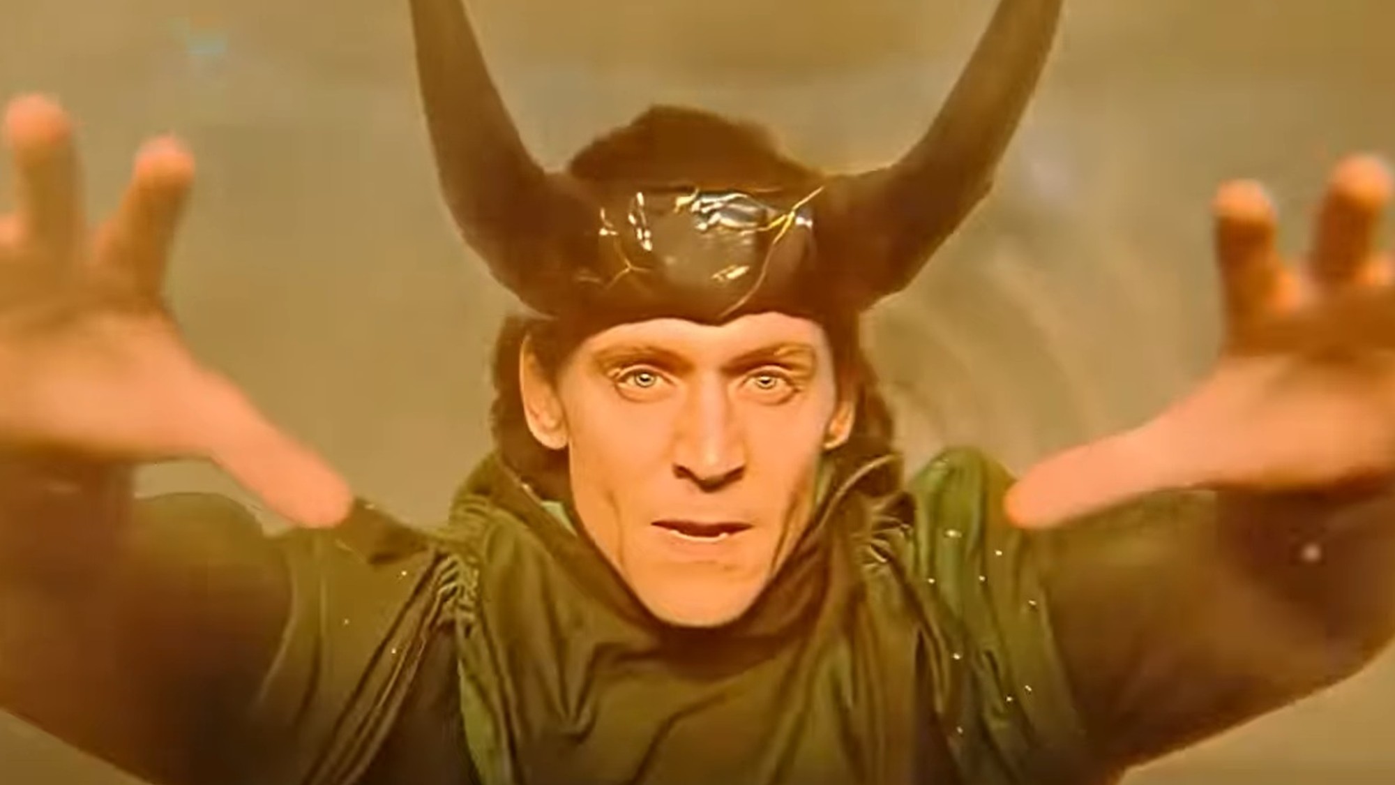 Tom Hiddleston with his arms outstretched in Loki