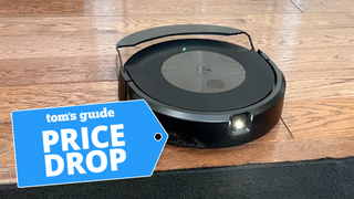 iRobot Roomba Combo j9+ on hardwood floor about to approach rug with Price Drop badge