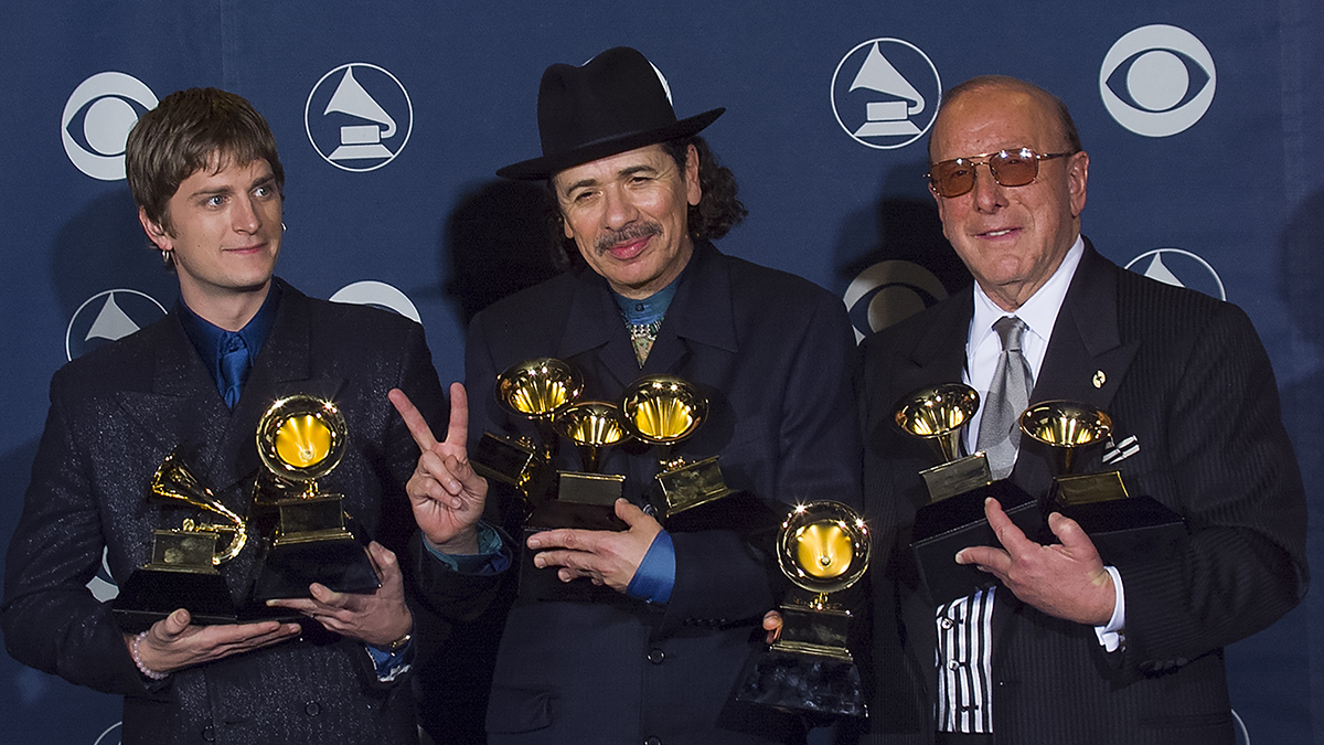 Multi-Grammy Winner Carlos Santana is joined by Rob Thomas and Clive Davis backstage at the Grammy Awards Show, February 23, 2000 in Los Angeles, California