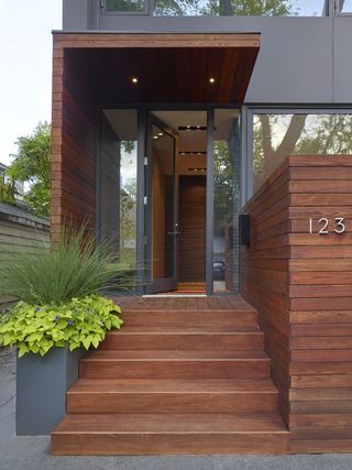 A selection of front door plants on a porch