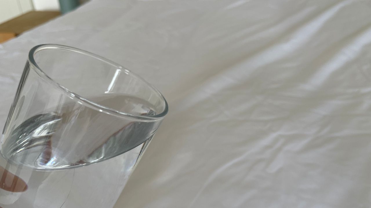 A glass of water being poured over Soak &amp; Sleep Anti-Bed Bug Mattress Encasement