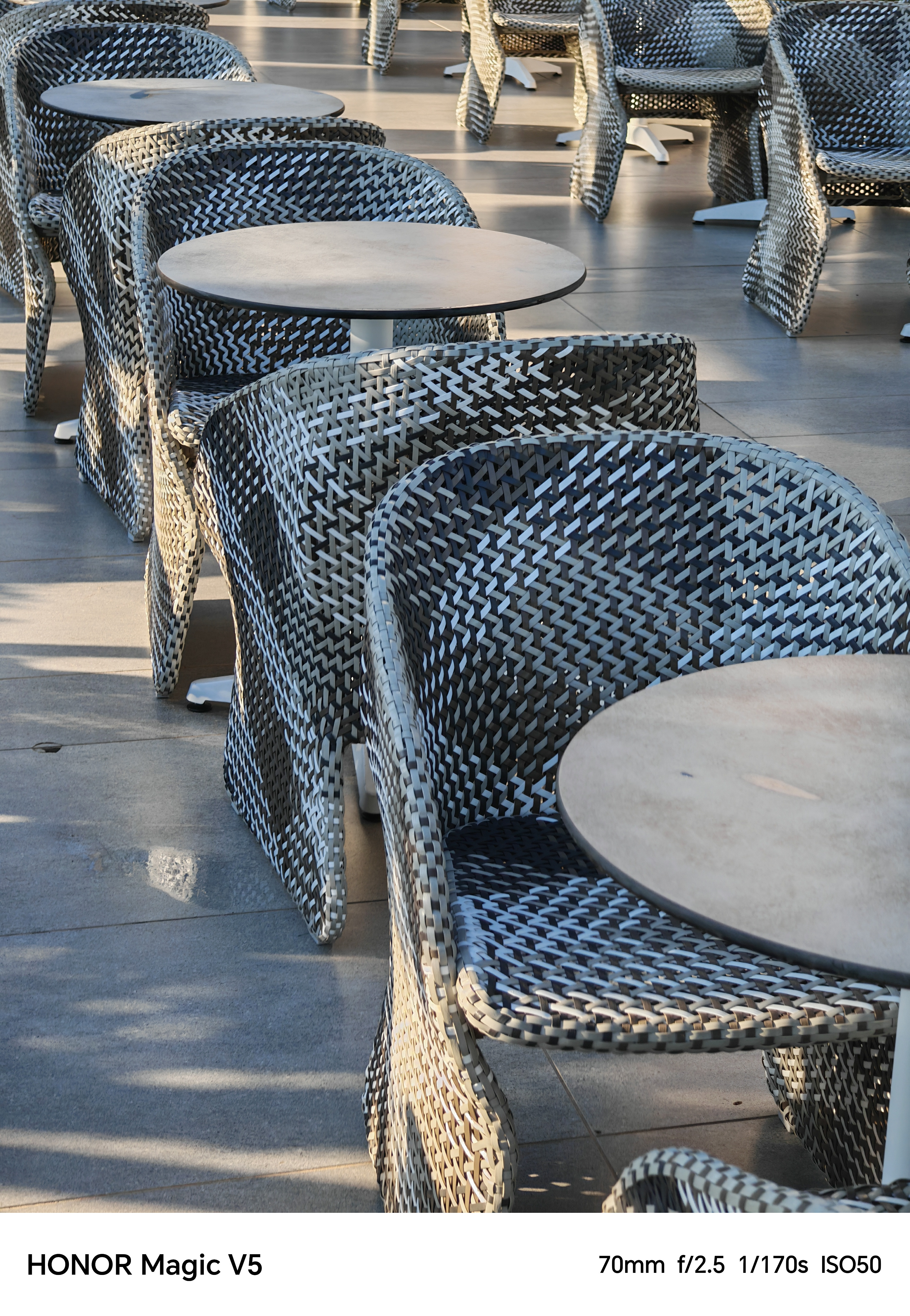 Empty tables and wicker chairs