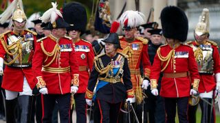 Princess Anne, Princess Royal in the gardens of Buckingham Palace during a royal salute from members of the military