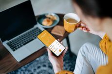 Woman investing in stocks at home