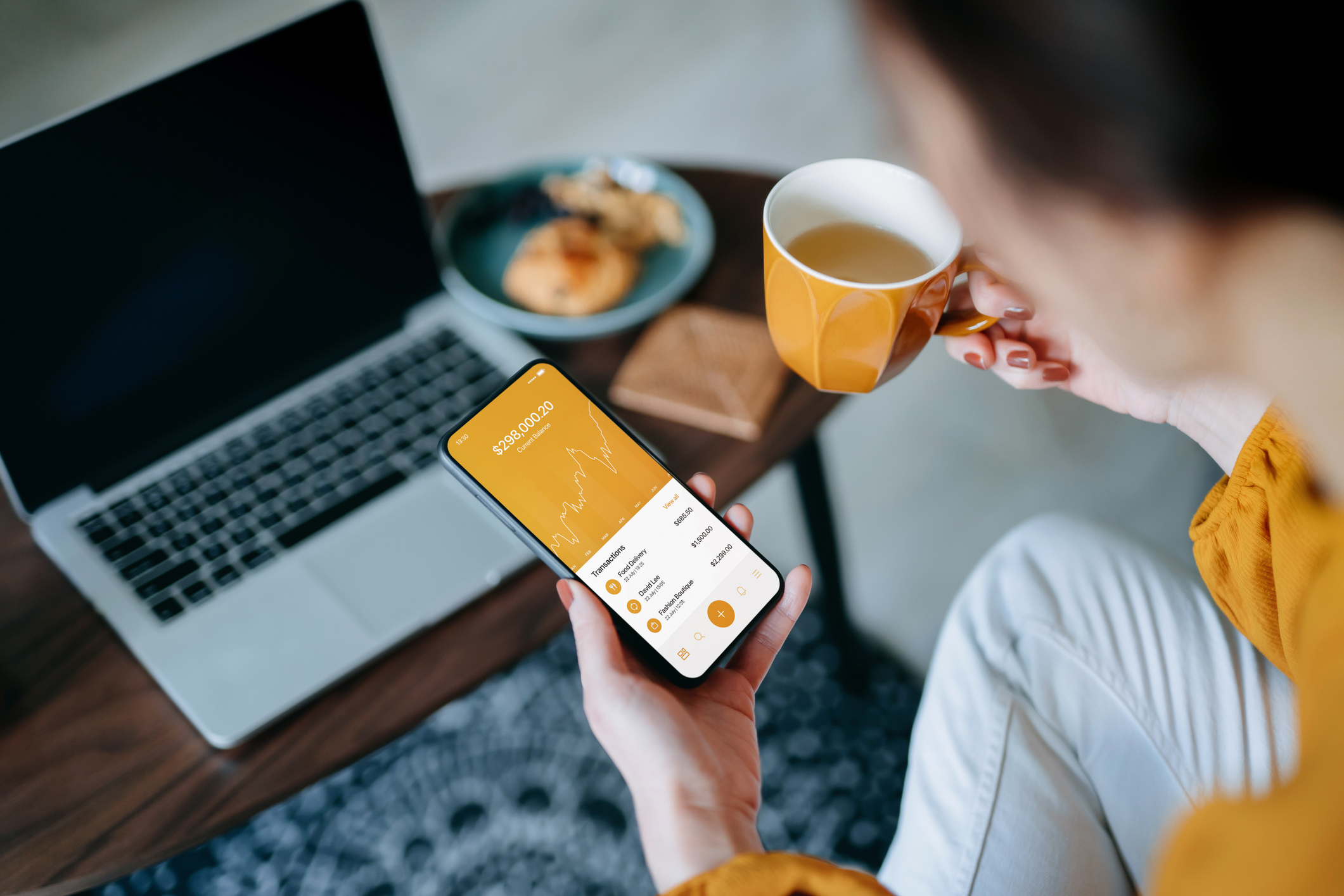 Woman investing in stocks at home