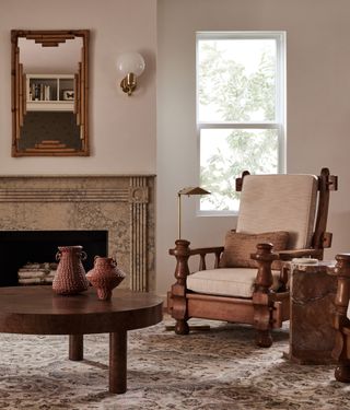 living room filled with textures like marble, rug, timber coffee table and antique-style armchair