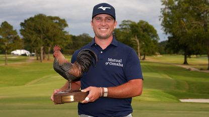 Steven Fisk with the Sanderson Farms Championship trophy