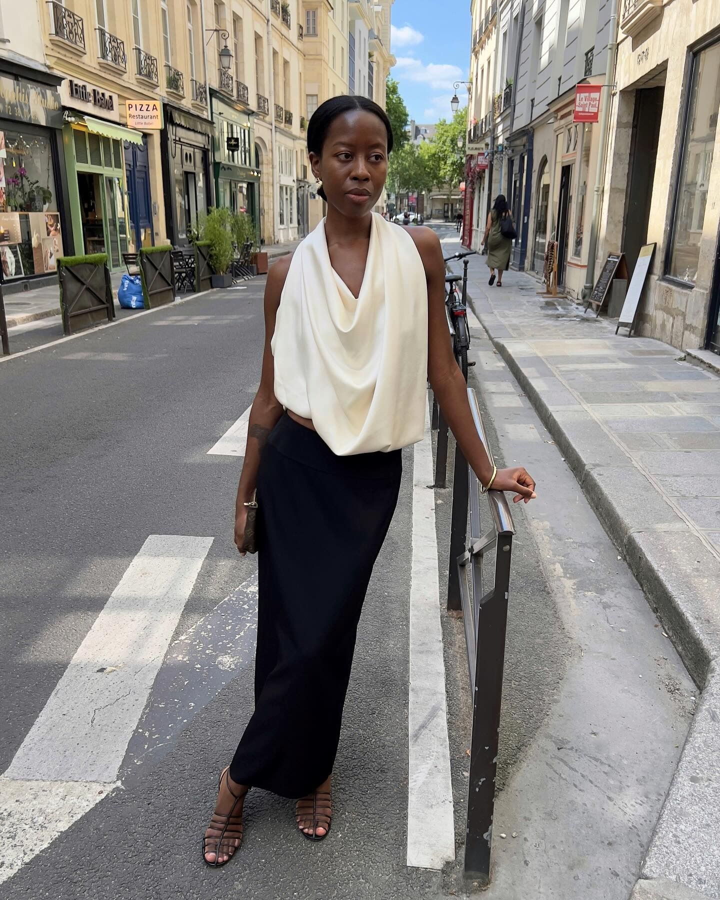 Woman wearing an elegant outfit idea that includes a cowl-neck top.
