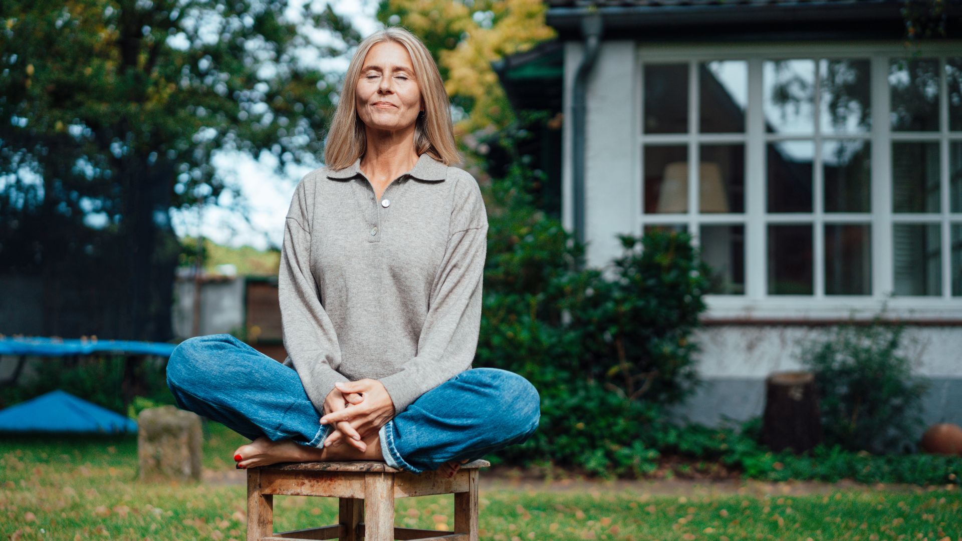 Woman sitting on stool, practising good posture