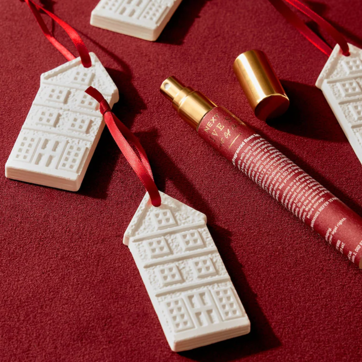A set of house-shaped scented ornaments and a room spray