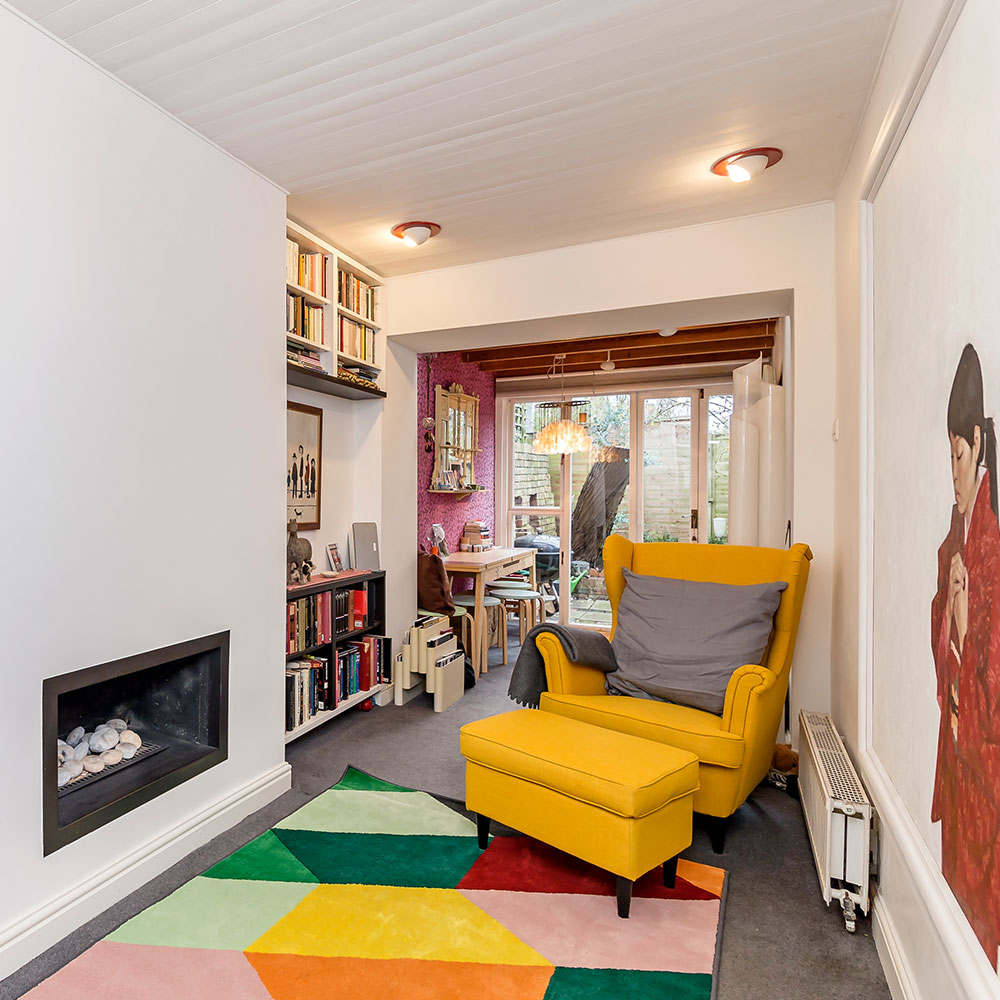 living room with white wall and chair