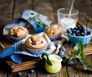 Blueberry muffins on a board.