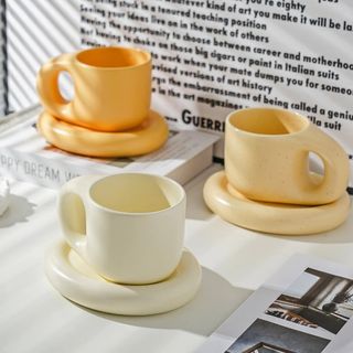 Three yellow chunky mugs and saucers