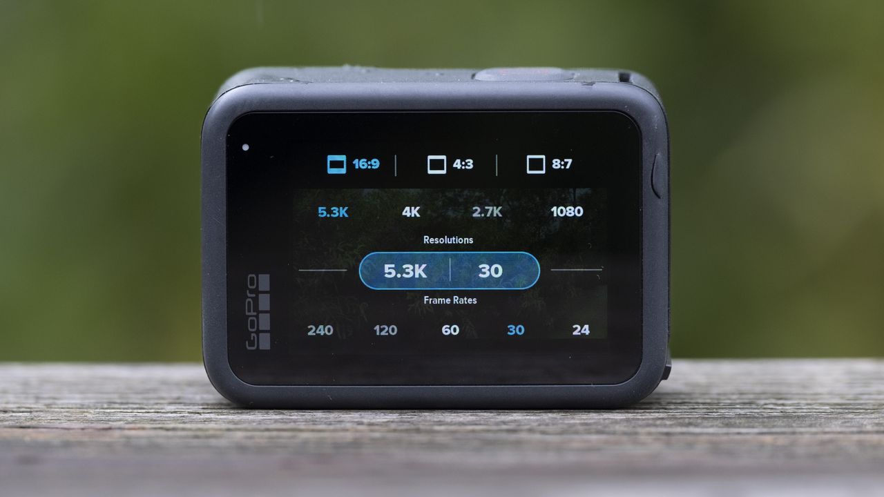 The GoPro Hero 11 Black action camera sitting on a wooden platform