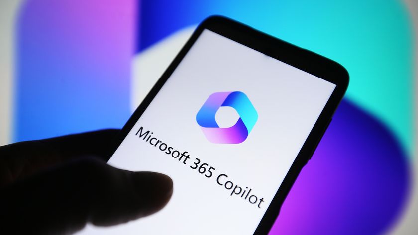 Microsoft 365 Copilot branding pictured on smartphone screen held in hand.