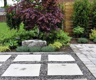 Pea gravel and stone pavers make up a patio