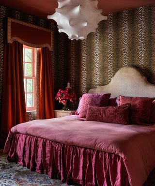 Bedroom decorated with animal print wall covering and jewel tone hues