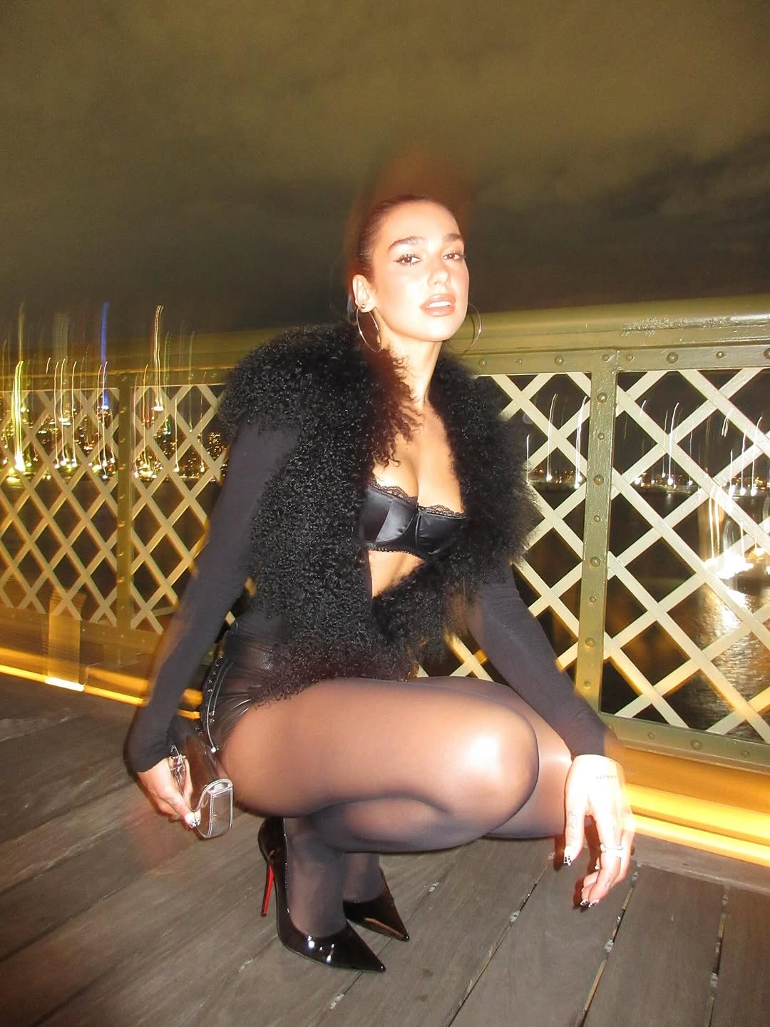 Dua Lipa wore a peekaboo bra underneath a fur-trimmed coat in Sept 2025