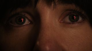 A close-up of a woman's eyes showing a red cross during the upcoming horror movie Frewaka.