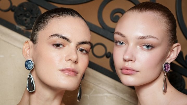 two runway models with glowing skin