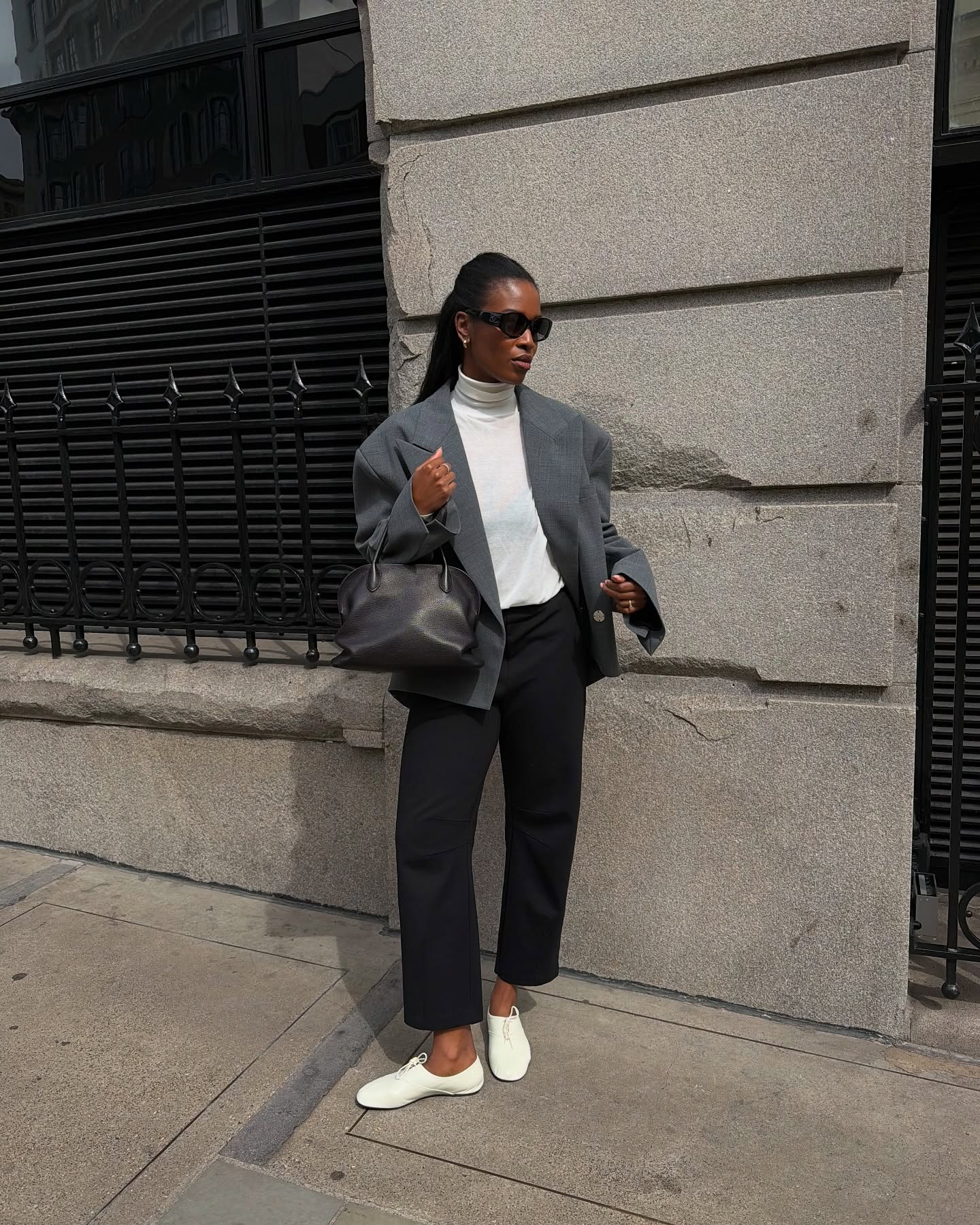 dated-summer-shoe-trends-2026: Marilyn Bathgate wears a grey blazer, white turtleneck, black trousers and white derby shoes
