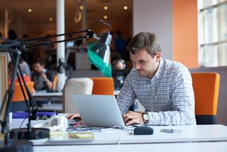 Man sitting behind a computer at an office