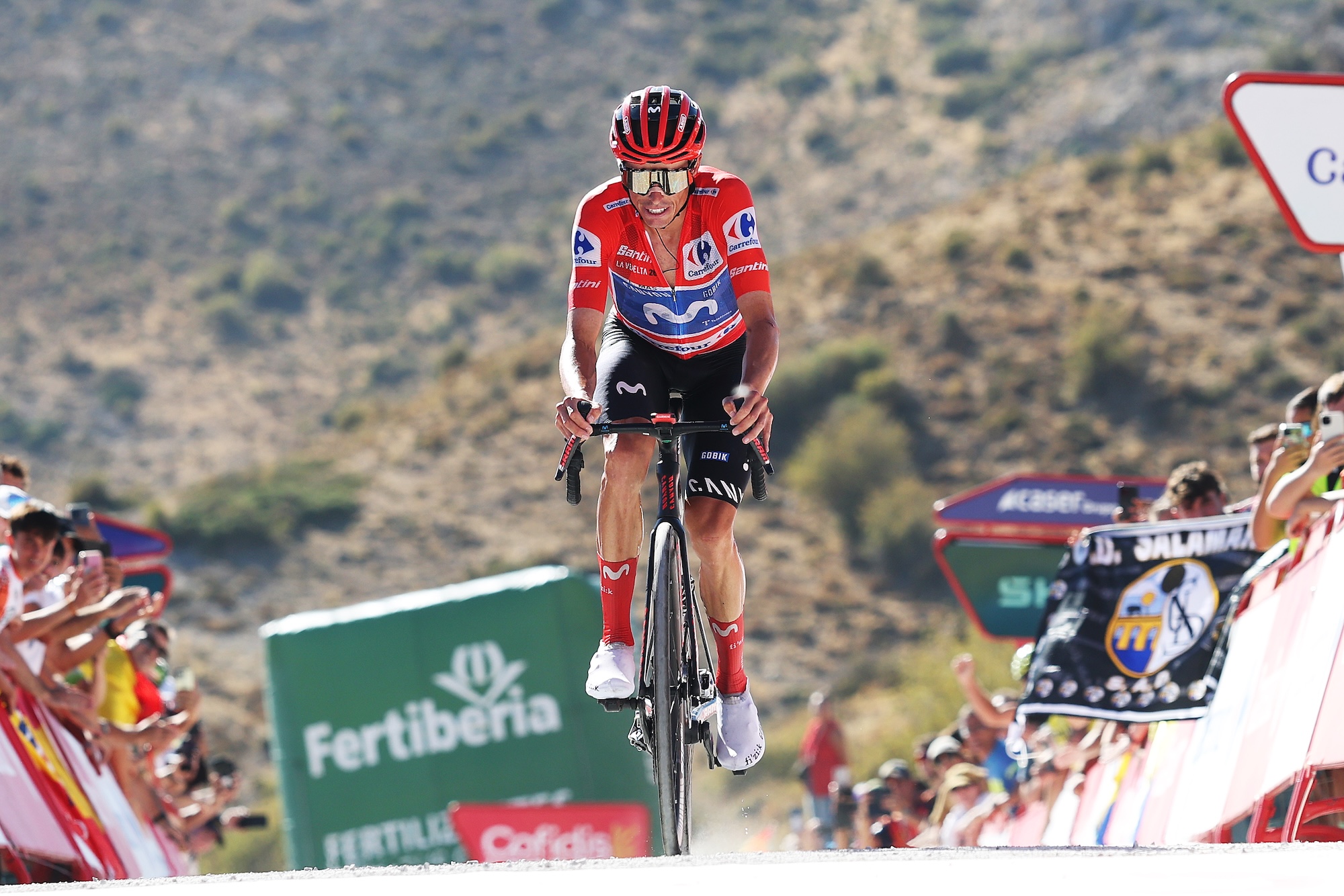 Enric Mas of Spain and Movistar Team and wearing the Red Leader Jersey, crosses the finish line on stage 20 of La Vuelta.