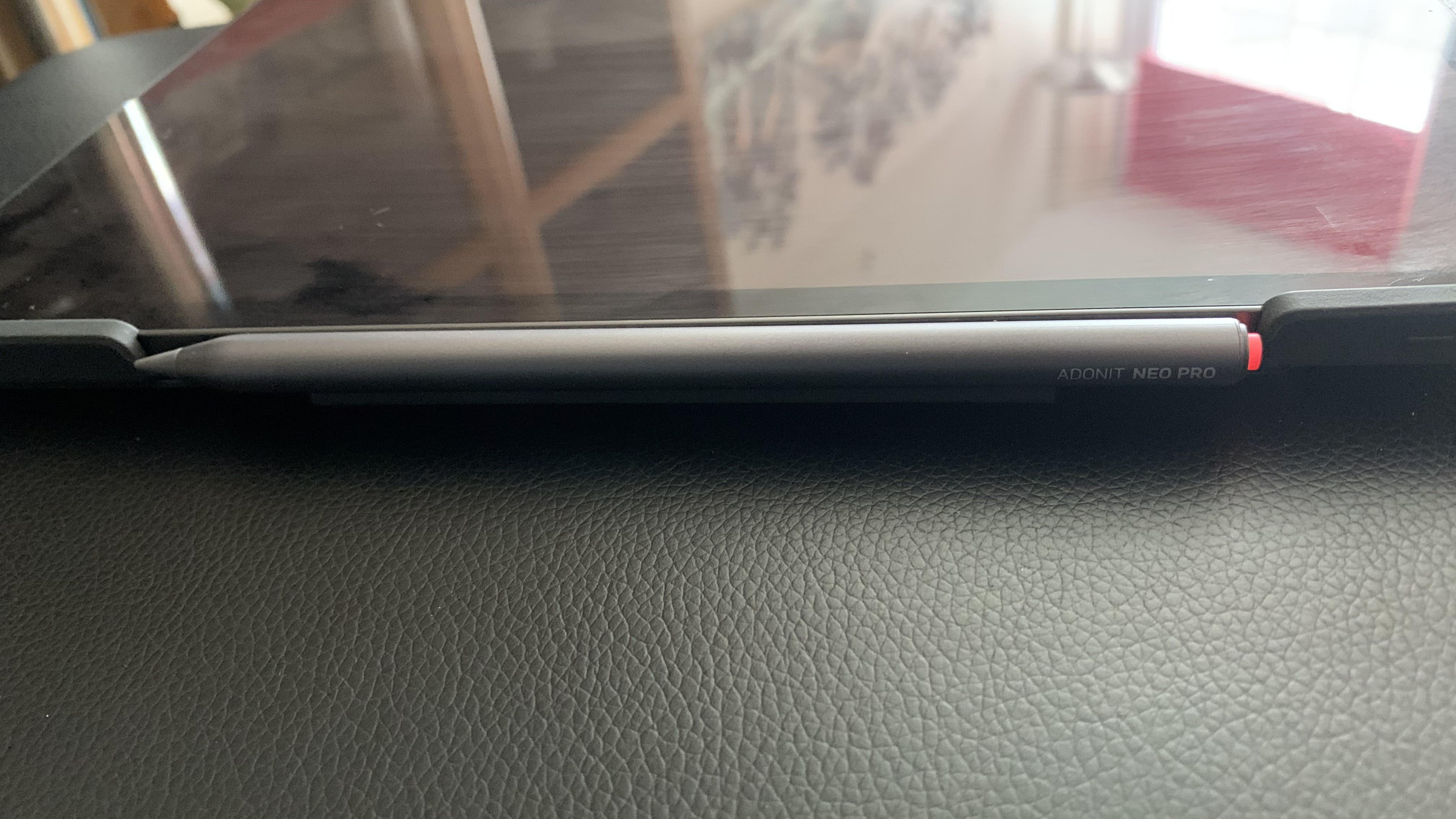 Adonit Neo Pro stylus clipped magnetically to the side of a tablet