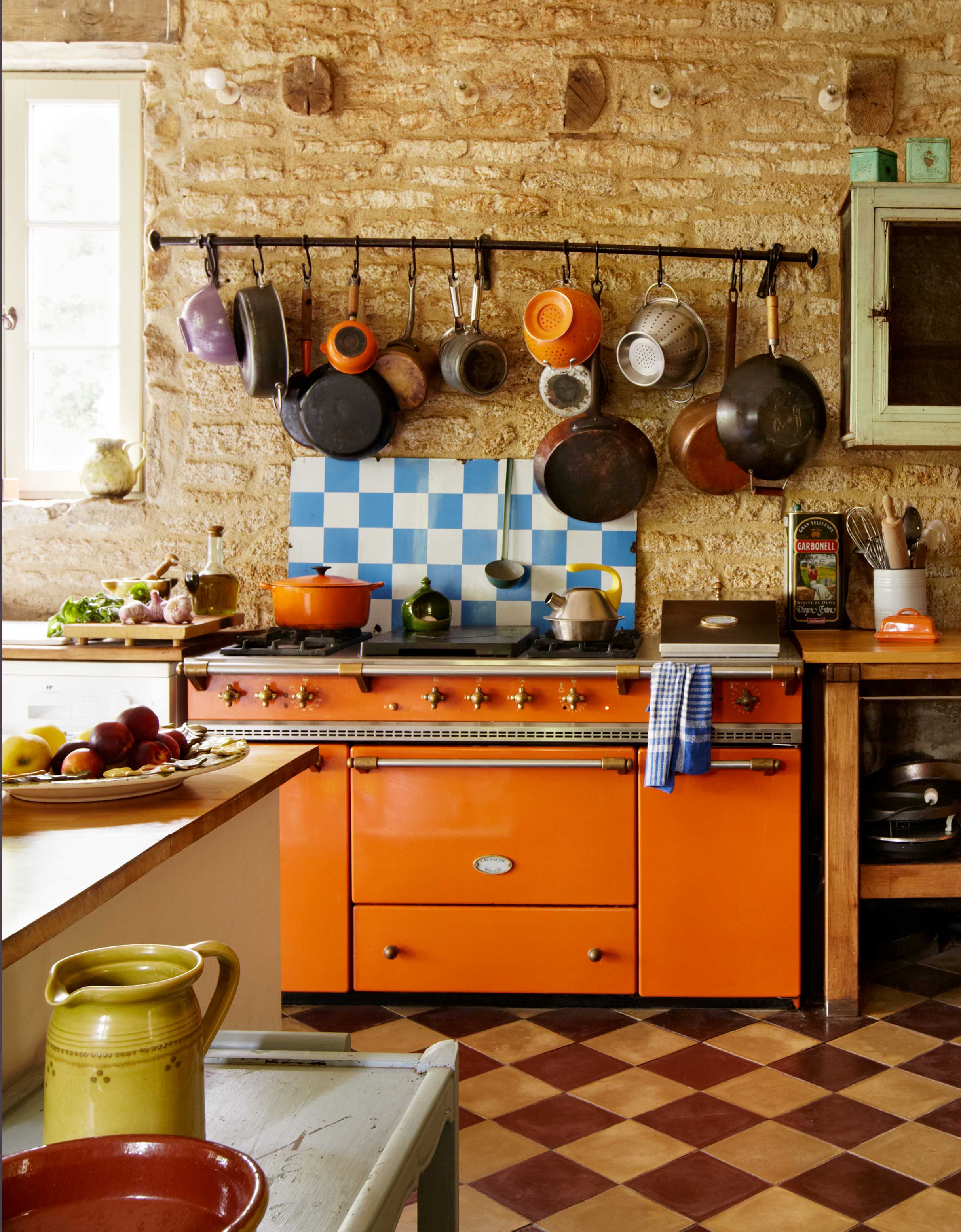 orange range cooker in rustic kitchen