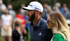 Dustin Johnson and Paulina Gretzky walk alongside one another at the 2020 Masters