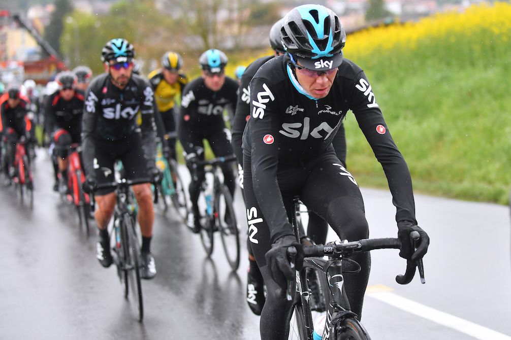 Chris Froome riding through cold and wet weather at the Tour de Romandie