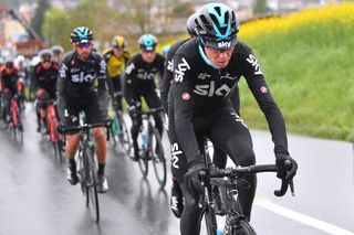 Chris Froome riding through cold and wet weather at the Tour de Romandie