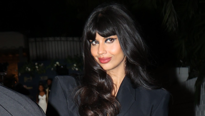 Jameela Jamil stunned in a cutout black pantsuit and Thom Browne handbag.