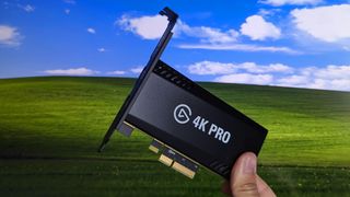 Elgato 4K Pro capture card in front of Bliss wallpaper