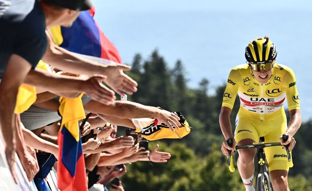 TOPSHOT UAE Team Emirates teams Slovenian rider Tadej Pogacar wearing the overall leaders yellow jersey cycles to the finish line to win the 7th stage of the 109th edition of the Tour de France cycling race 1763 km between Tomblaine and La Super Planche des Belles Filles in eastern France on July 8 2022 Photo by Marco BERTORELLO AFP Photo by MARCO BERTORELLOAFP via Getty Images