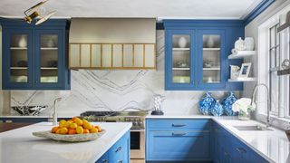 blue kitchen with marble backsplash