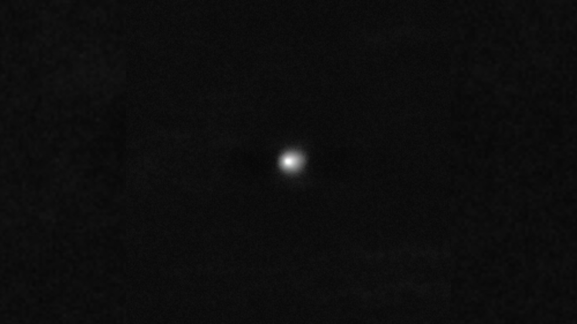 a grainy white blob on a black background