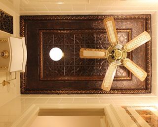 bathroom with opulent patterned tin tiles on the ceiling