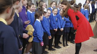 AYRSHIRE, UNITED KINGDOM - MARCH 05: Catherine, Countess of Strathearn stops to talk to some school children during a visit to Dumfries House on March 05, 2013 in Ayrshire, Scotland. The Duke and Duchess of Cambridge braved the bitter cold to attend the opening of an outdoor centre in Scotland today. The couple joined the Prince of Wales at Dumfries House in Ayrshire where Charles has led a regeneration project since 2007. Hundreds of locals and 600 members of youth groups including the Girl Guides and Scouts turned out for the official opening of the Tamar Manoukin Outdoor Centre.