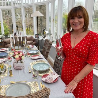 lorraine kelly with red dress and with dining table with dishes
