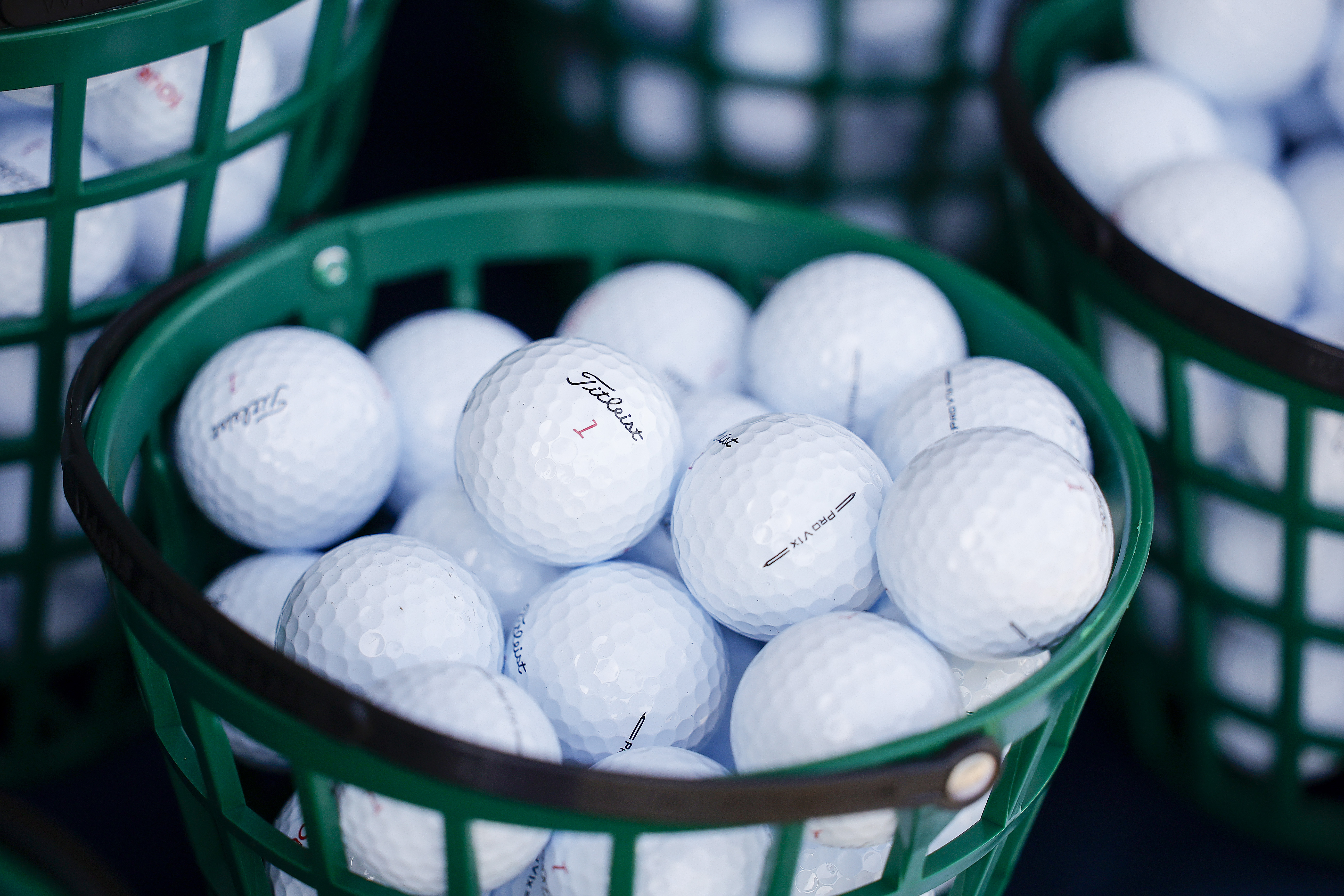 A bucket full of Titleist golf balls