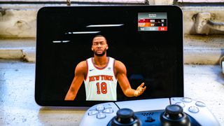 The iPad mini 6 2021 playing NBA 2K21 Arcade Edition with a PS5 controller in the frame