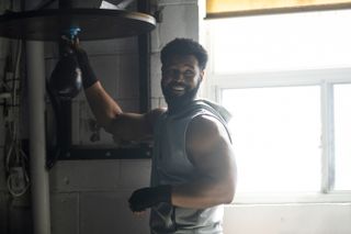 Isaiah Mustafa as John Sampson, adjusting a boxing speed bag, in 'Cross'