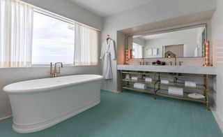 Bathroom view of bath tub and long sink